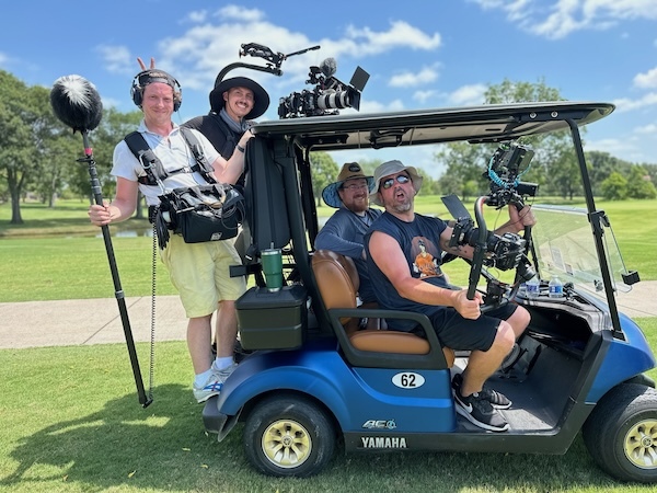 Video production crew rides a golf cart in Houston Texas