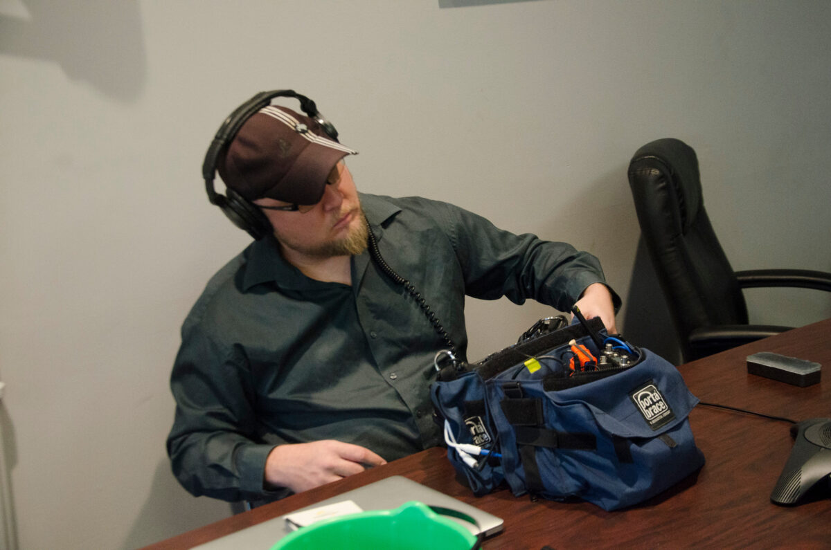 Behind the scenes on Cut To Create's video production shoot for Virtuix utilizing a green screen featuring audio engineer, Kent Ohler