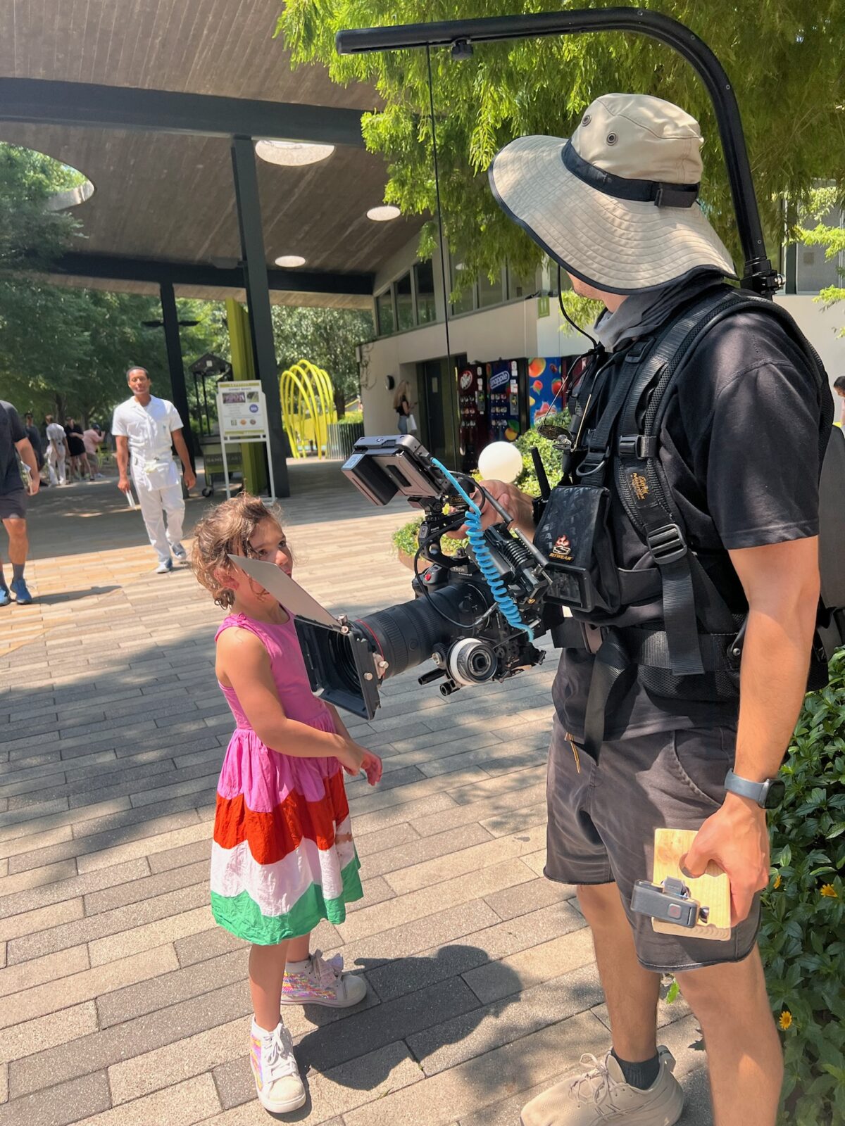 Esteban Valencia talks with a little girl while holding his camera