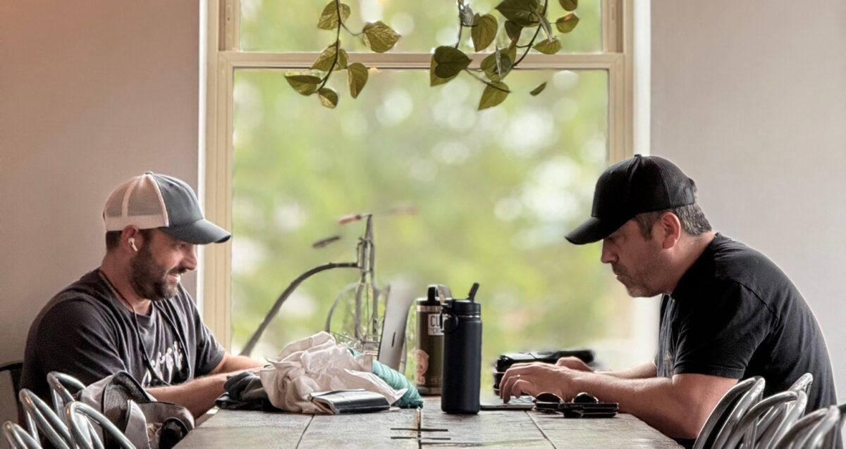 Scott Marett and Zach Jankovic sitting at a coffee shop in Lexington, Ohio transferring content from a video production shoot for BlueScope
