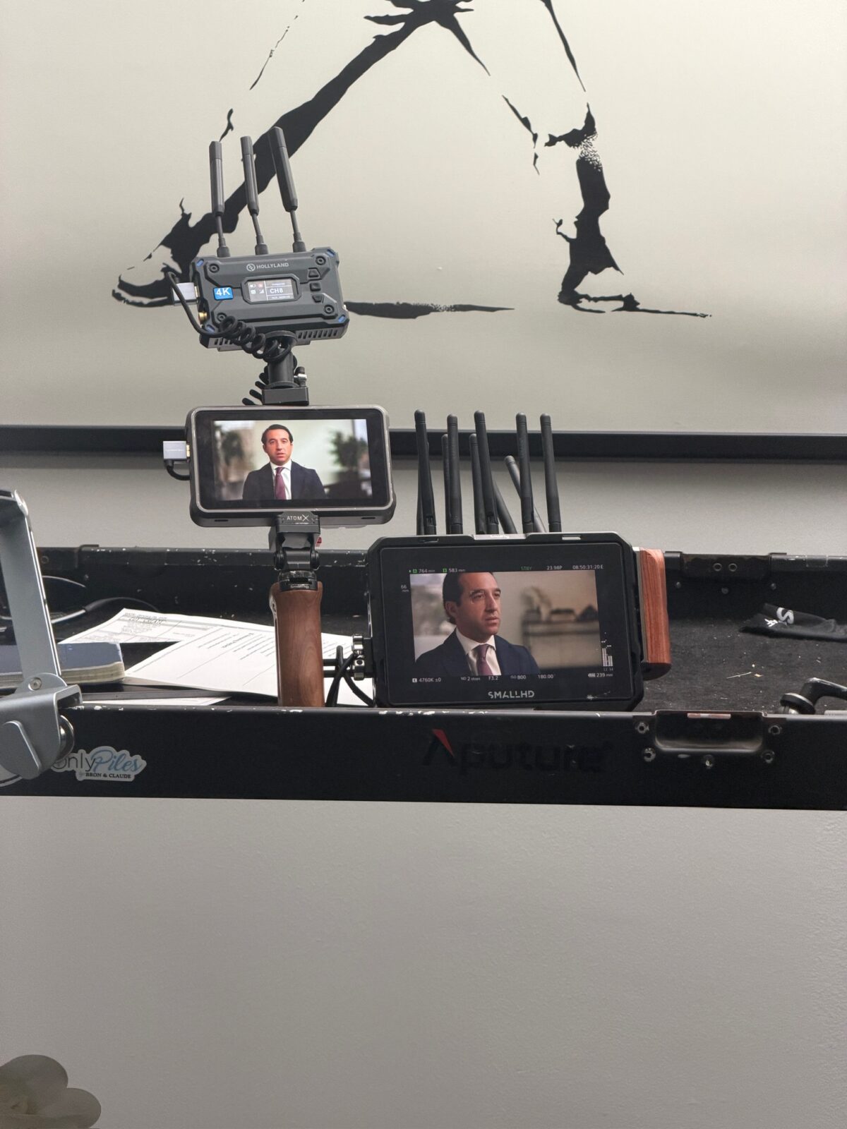 Camera monitors showing Adam Funk during a filmed attorney interview