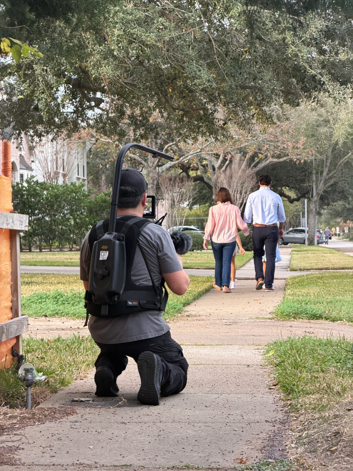 Camera operator filming family walking scene for Funk Law Group testimonial