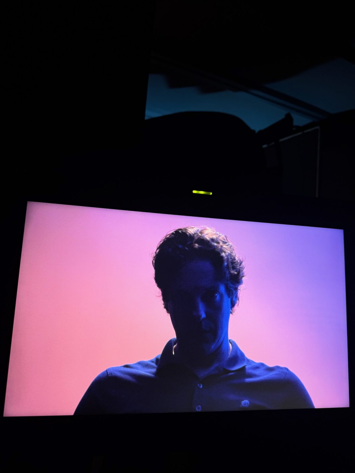 Scott Ross sitting in a back lit interview set up for a project for Rice University's Kinder Institute for Urban Research
