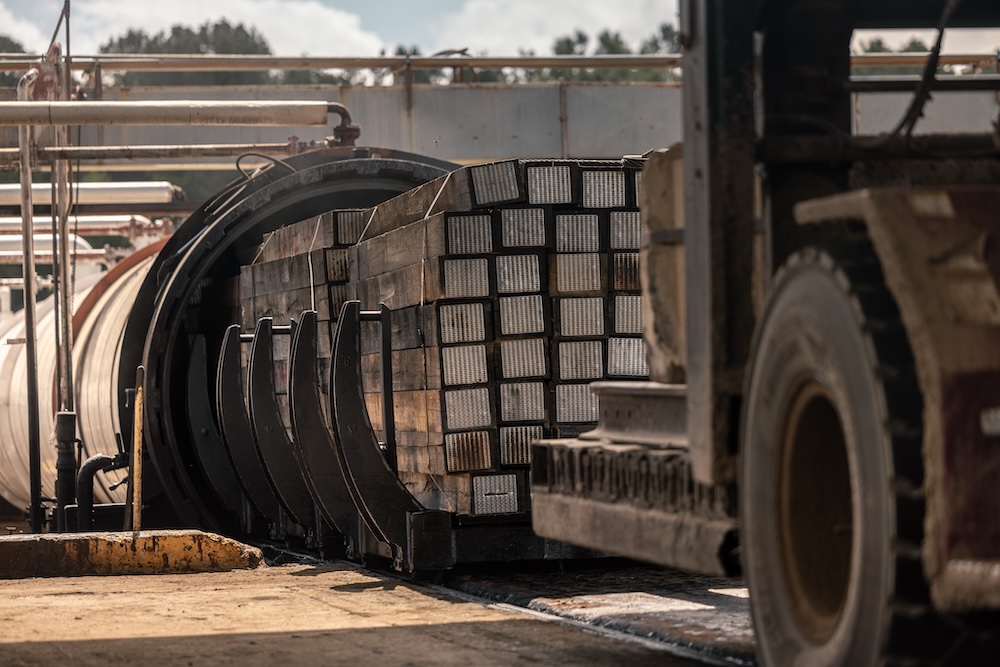 Stacks of timber being loaded for transport.